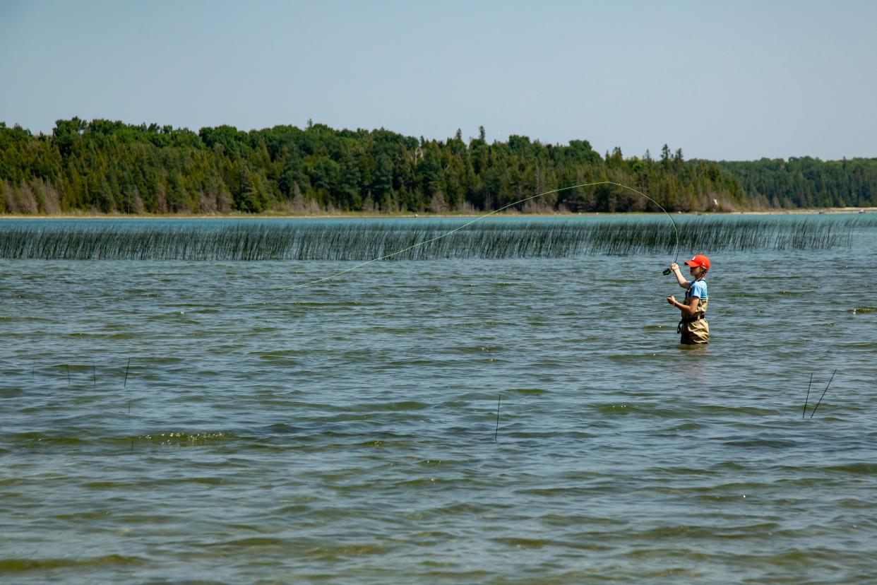 Emme Plackemeier casts a line off Beaver Island during a June, girls-only fishing excursion with the Harbor Springs Adventure Club. Plackemeier is a 7th grader this school year and serves as a mentor for younger members of the Adventure Club.