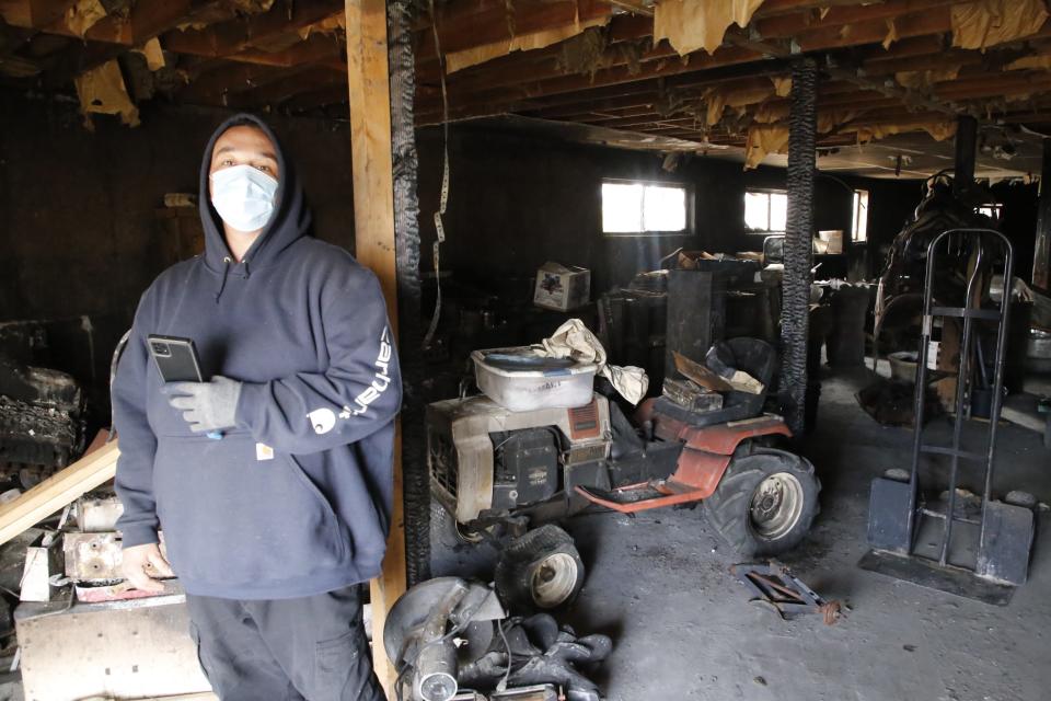 Dakota Green stands in the charred basement of his family's home north of Aztec on Dec. 21 after a blaze gutted much of the structure on Dec. 11.