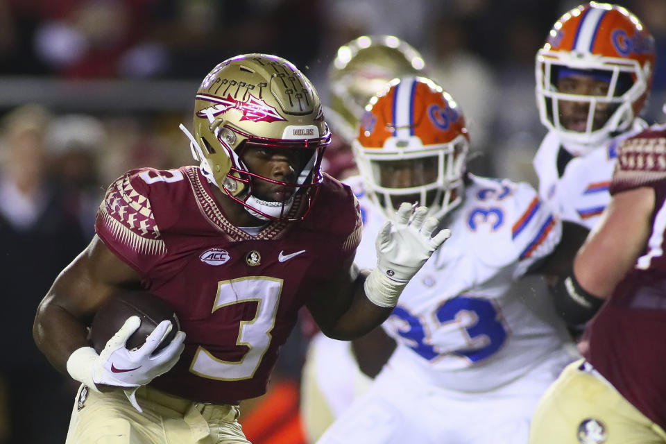 FILE - Florida State running back Trey Benson (3) runs for a touchdown in the first quarter of an NCAA college football game against Florida on Nov. 25, 2022, in Tallahassee, Fla. After their worst regular season finish in over two decades, the Sooners look to win their third straight bowl and first under coach Brent Venables with a winning record at stake on Dec. 29, 2022. The Seminoles had their first winning season since coach Jimbo Fisher left the program in 2017 and look for their first bowl win since the 2017 season. Oklahoma is led by Big 12 offensive newcomer of the year in quarterback Dillon Gabriel and the Seminoles will have dominant running back Benson. (AP Photo/Phil Sears, File)