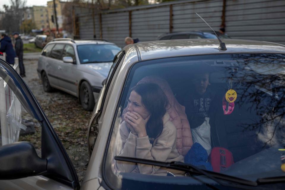 A Ukranian woman sits in a car with her family after they managed to flee from the Russian occupied territory of Kherson, on November 5, 2022, in Zaporizhzhia.