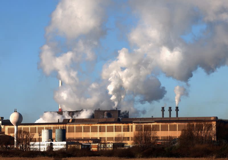 FILE PHOTO: Smoke rises from chimneys at a factory in the port of Dunkirk