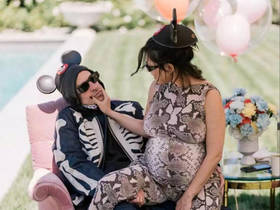 Travis Barker and Kourtney Kardashian Barker posed together during their Disneyland-themed baby shower in September 2023 (@kourtneykardash/Instagram) (Instagram)