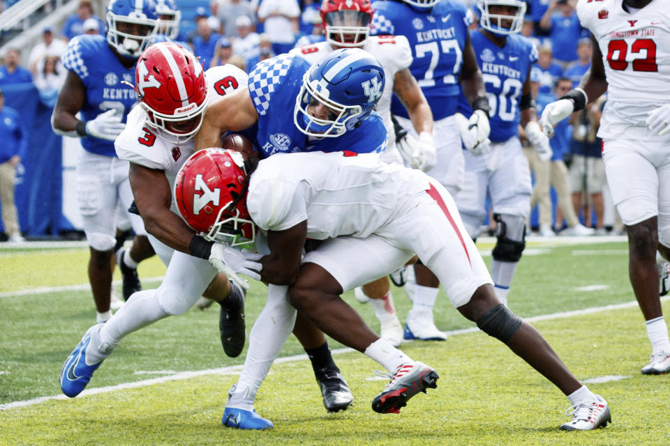 Kentucky quarterback Will Levis, center, gets tackled by Youngstown State linebacker Alex Howard (3) and defensive back D'Marco Augustin during the second half of an NCAA college football game in Lexington, Ky., Saturday, Sept. 17, 2022. (AP Photo/Michael Clubb)