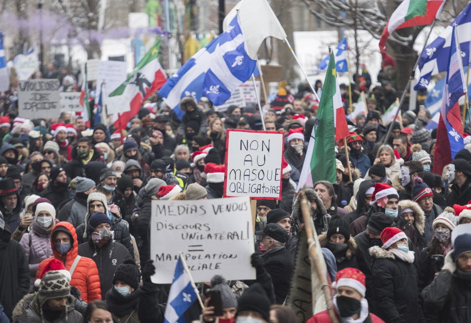 People participate in a demonstration in Montreal, Sunday, Dec. 20, 2020, protesting measures implemented by the Quebec government to help stop the spread of COVID-19. The COVID-19 pandemic continues in Canada and around the world. (Graham Hughes/The Canadian Press via AP)