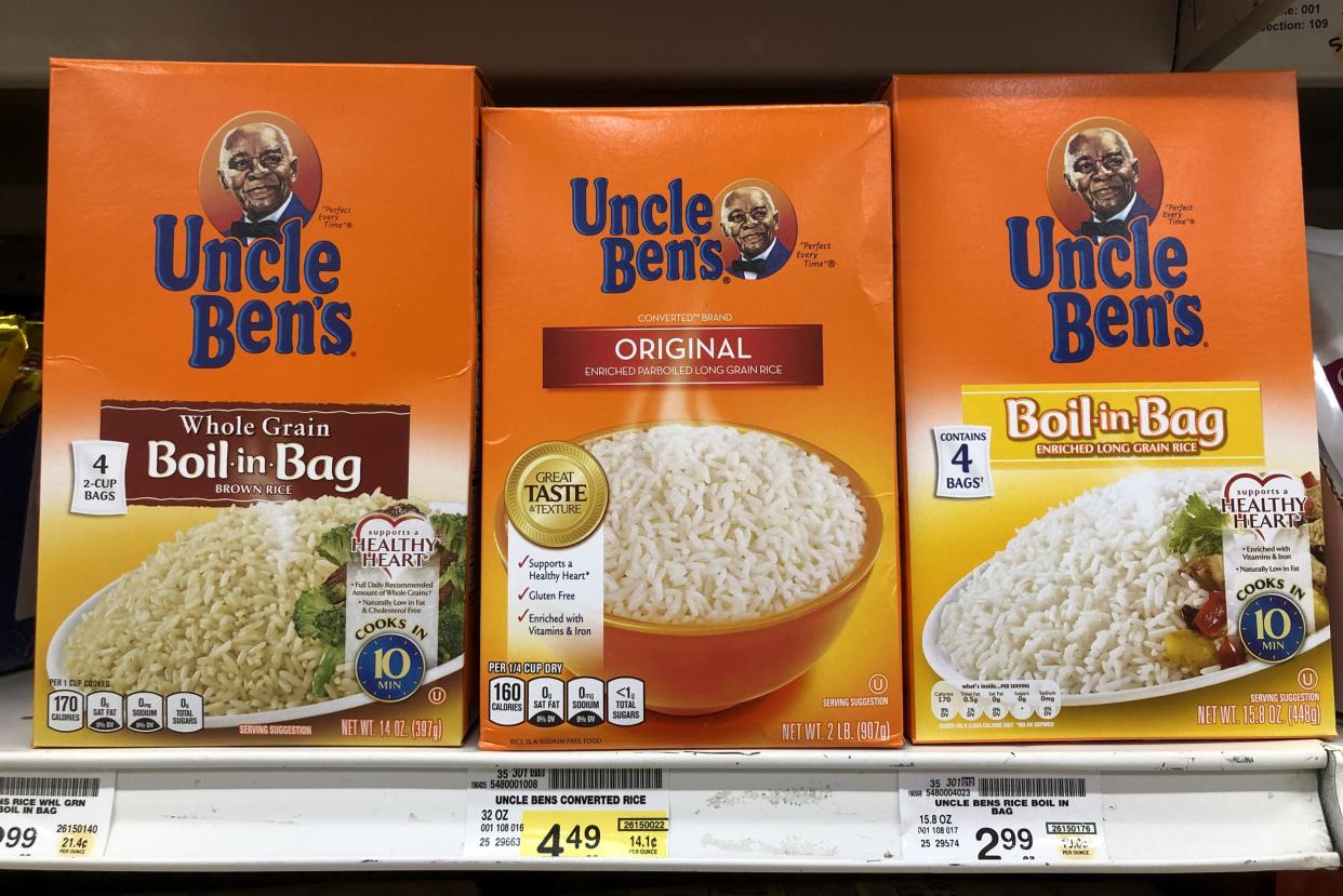 Boxes of Uncle Ben's rice displayed on a shelf at a Safeway store, three shown in the foreground, different kinds, prices shown on the bottom