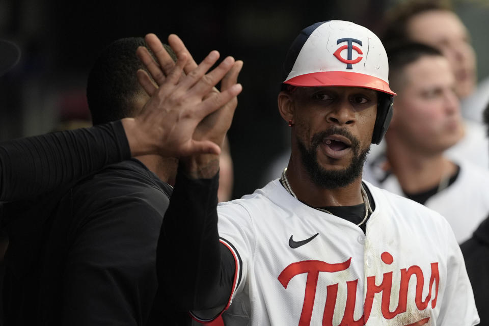 Minnesota Twins' Byron Buxton celebrates in the dugout after scoring off a fielder's choice hit by teammate Ryan Jeffers during the seventh inning of a baseball game Tuesday, July 2, 2024, in Minneapolis. (AP Photo/Abbie Parr)