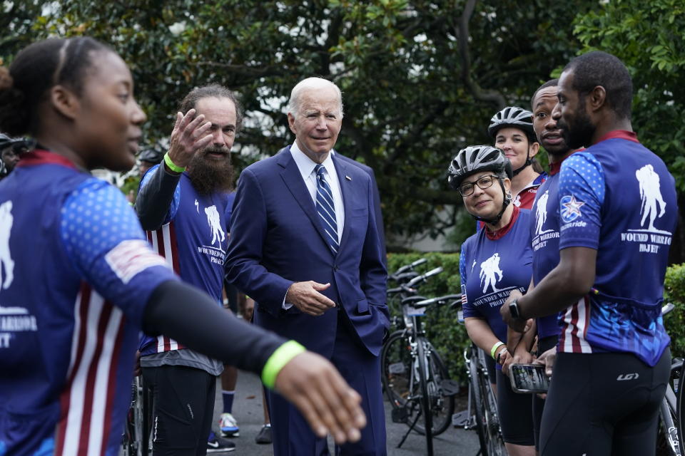 President Joe Biden talks to riders at the White House in Washington, Thursday, June 23, 2022, during an event to welcome wounded warriors, their caregivers and families to the White House as part of the annual Soldier Ride to recognize the service, sacrifice, and recovery journey for wounded, ill, and injured service members and veterans. (AP Photo/Susan Walsh)