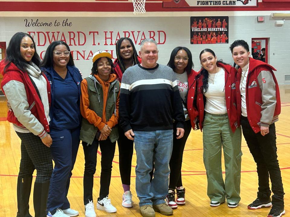 The Vineland High School girls' basketball team from the conference championship 2010-11 season was honored before Thursday's game. Rick Baruffi (center) was the head coach for the Fighting Clan.