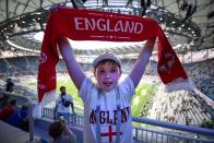 <p>Showing his colours: a young England fan gets behind his side </p>