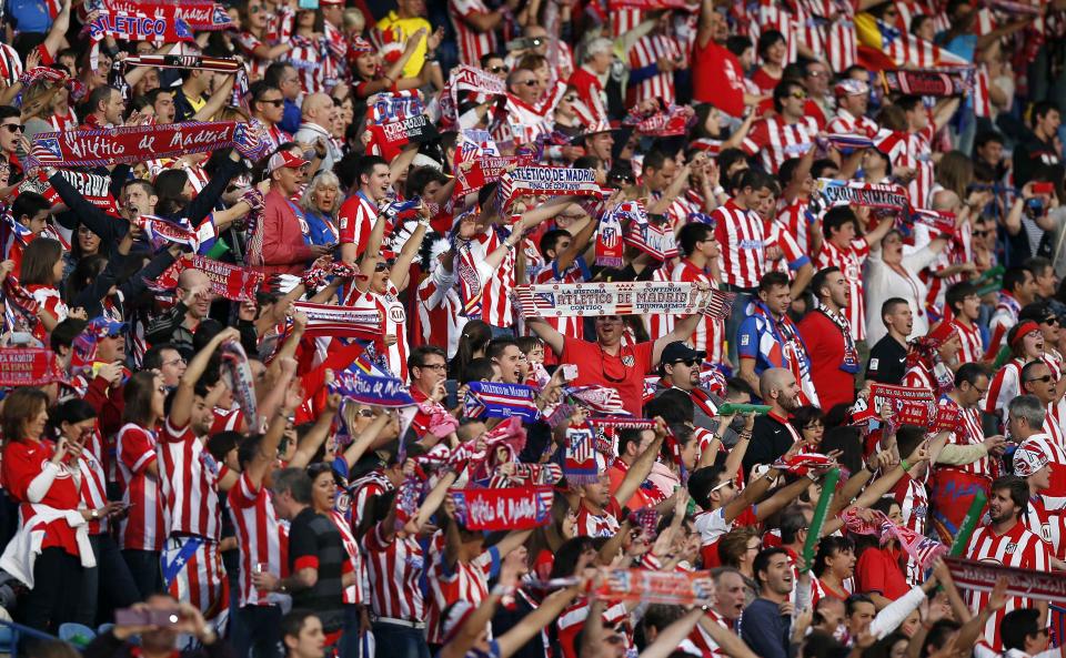 Atletico Madrid supporters react before their Champions League final soccer match against Real Madrid at a fan zone at Vicente Calderon stadium in Madrid May 24, 2014. Atletico Madrid and Real Madrid play their Champions League final soccer match in Lisbon. REUTERS/Andrea Comas (SPAIN - Tags: SPORT SOCCER)