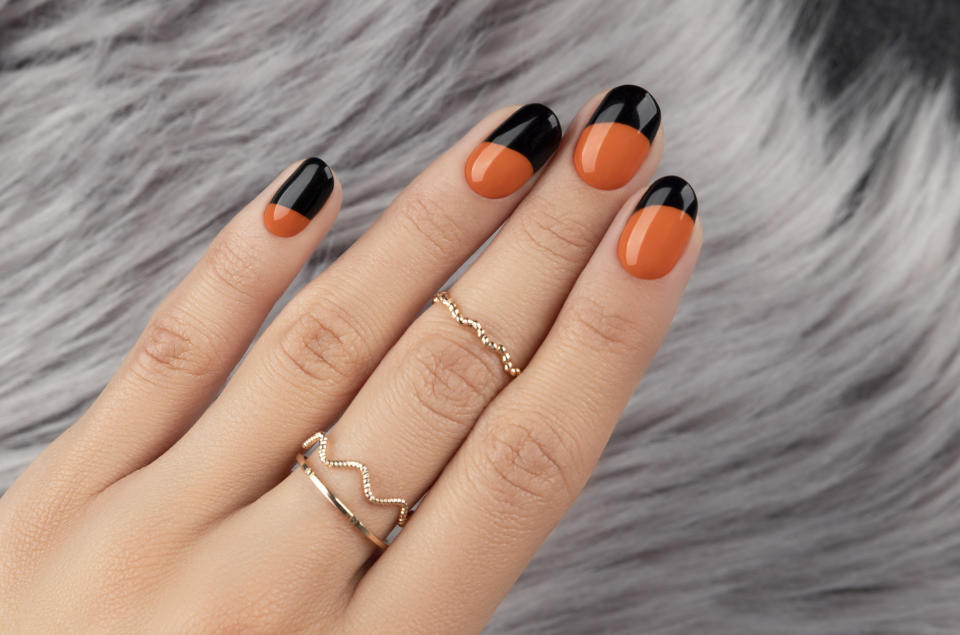 Orange and black Halloween nail design.