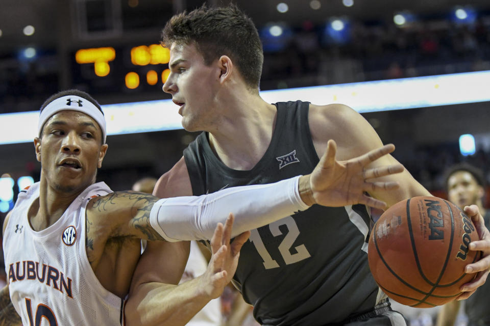 Auburn guard Samir Doughty, left, gets a hand in on a drive by Iowa State forward Michael Jacobson, right, during the first half of an NCAA college basketball game Saturday, Jan. 25, 2020, in Auburn, Ala. (AP Photo/Julie Bennett)