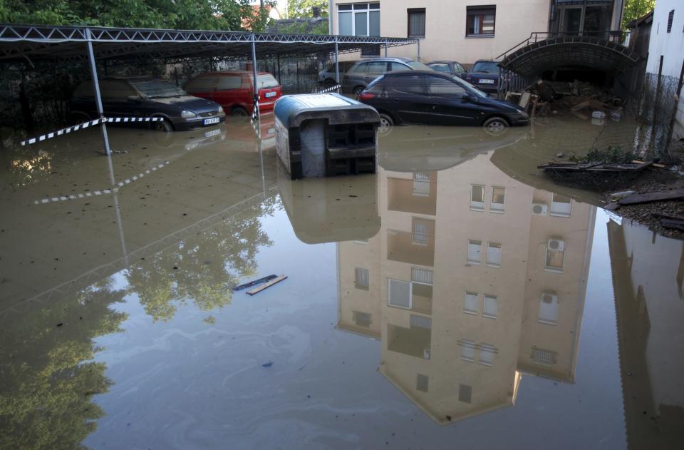 Damaged cars are seen stranded in flood waters in the town of Obrenovac