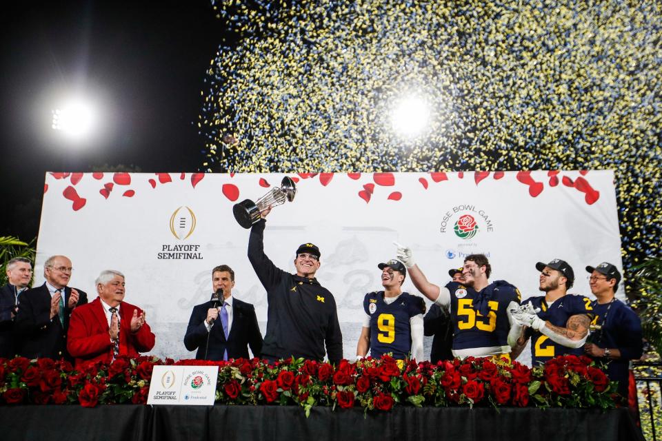 Michigan coach Jim Harbaugh lifts up the Rose Bowl trophy after 27-20 overtime win over Alabama at Rose Bowl Stadium in Pasadena, California, on Monday, Jan. 1, 2024.