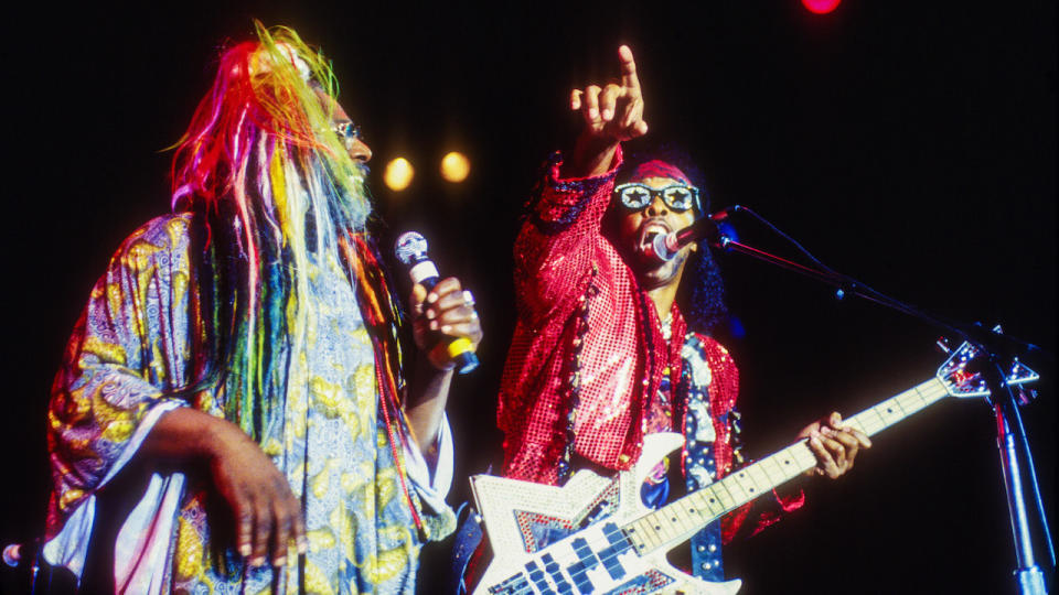 American Rock, Funk, and Soul musician and bandleader George Clinton (left), along with Bootsy Collins (born William Earl Collins) on electric bass, leads his group Parliament-Funkadelic (or P-Funk) at a Fourth of July celebration at Central Park SummerStage, New York, New York, July 4, 1996.
