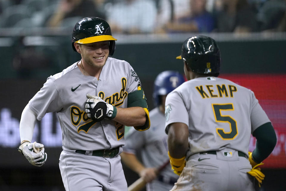 Oakland Athletics' Nick Allen (2) and Tony Kemp (5) celebrate Allen's solo home run during the third inning of the team's baseball game against the Texas Rangers in Arlington, Texas, Monday, Aug. 15, 2022. (AP Photo/Tony Gutierrez)