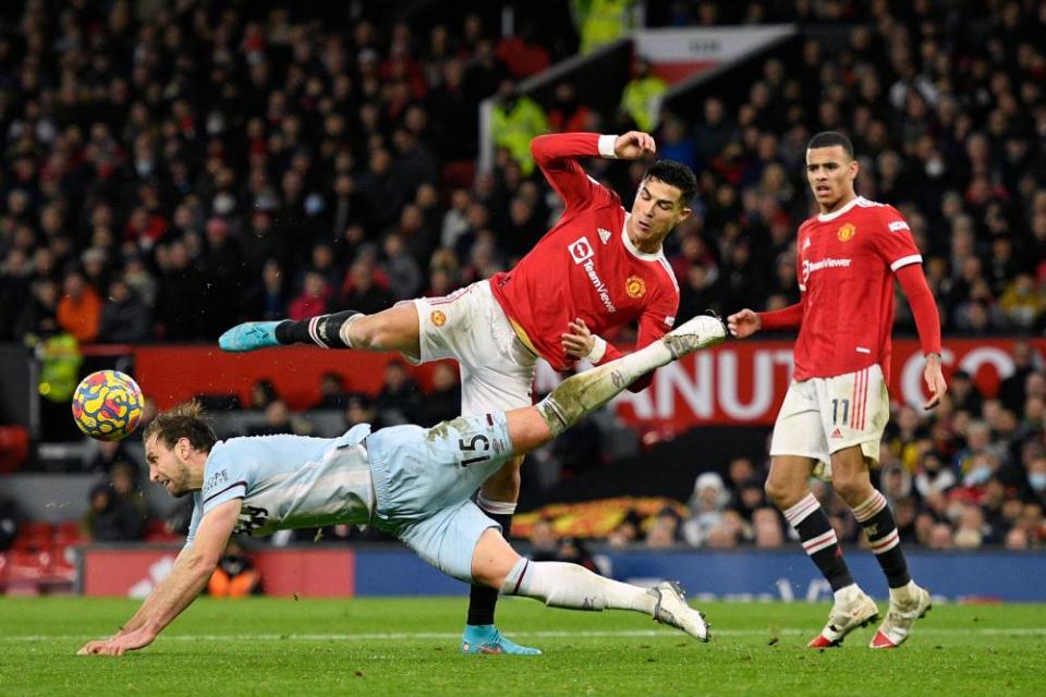 Craig Dawson heads clear from Cristiano Ronaldo.