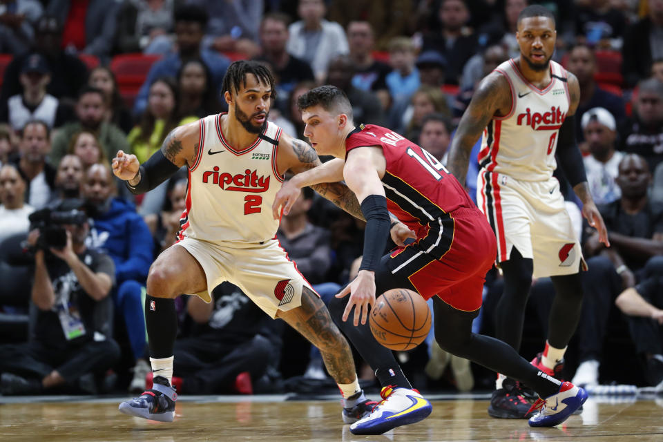 Miami Heat guard Tyler Herro (14) loses control of the ball as he is guarded by Portland Trail Blazers guard Gary Trent Jr. (2) during the first half of an NBA basketball game, Sunday, Jan. 5, 2020, in Miami. (AP Photo/Wilfredo Lee)