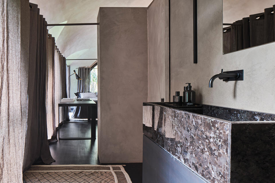 Nearly every space, including the bathrooms, uses the same plaster and Brazilian slate flooring for continuity.