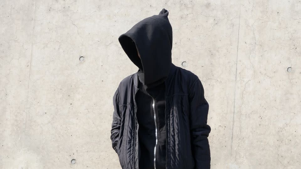 A Fashion Week attendee in all-black, complete with hoodie, bomber jacket and chunky futuristic footwear. - Kahyun Lee/CNN