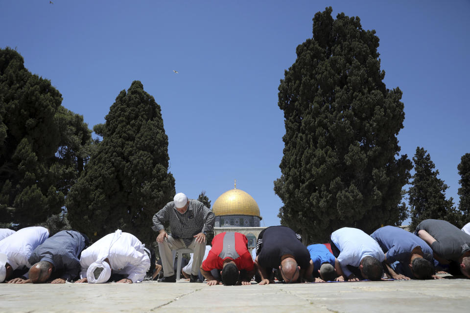 Muslim worshippers take part in Friday prayers at the Dome of the Rock Mosque in the Al-Aqsa Mosque compound in the Old City of Jerusalem, Friday, May 14, 2021. (AP Photo/Mahmoud Illean)