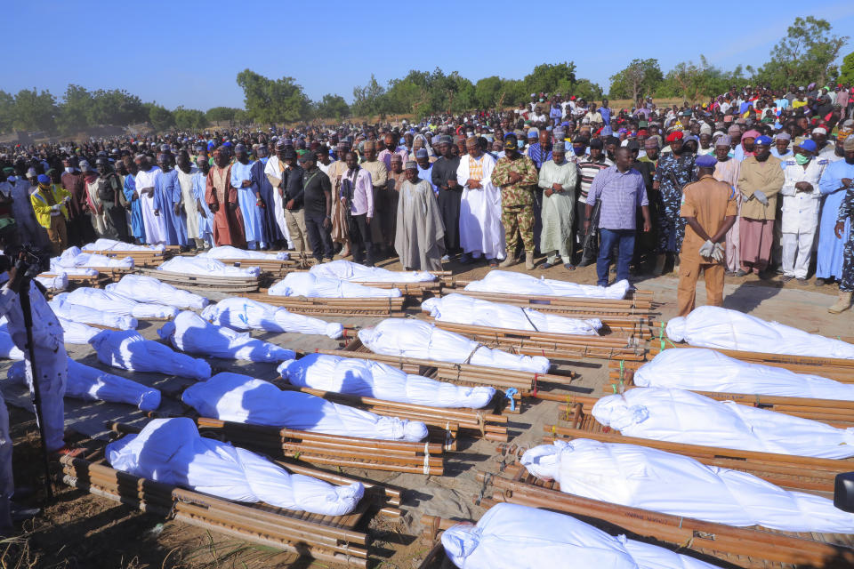 People attend a funeral for those killed by suspected Boko Haram militants in Zaabarmar, Nigeria, Sunday, Nov. 29, 2020. Nigerian officials say suspected members of the Islamic militant group Boko Haram have killed at least 40 rice farmers and fishermen while they were harvesting crops in northern Borno State. The attack was staged Saturday in a rice field in Garin Kwashebe, a Borno community known for rice farming. (AP Photo/Jossy Ola)