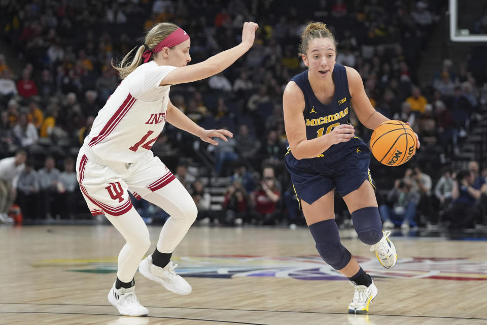 Michigan guard Jordan Hobbs, right, works toward the basket as Indiana guard Sara Scalia , left,defends during the first half of an NCAA college basketball quarterfinal game at the Big Ten women's tournament Friday, March 8, 2024, in Minneapolis. (AP Photo/Abbie Parr)