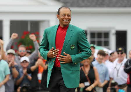 FILE PHOTO: Golf - Masters - Augusta National Golf Club - Augusta, Georgia, U.S. - April 14, 2019. Tiger Woods of the U.S. celebrates with with his green jacket after winning the 2019 Masters. REUTERS/Lucy Nicholson/File Photo