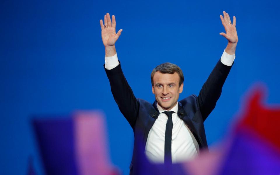 French centrist presidential candidate Emmanuel Macron waves before addressing his supporters at his election day headquarters in Paris - Credit: AP