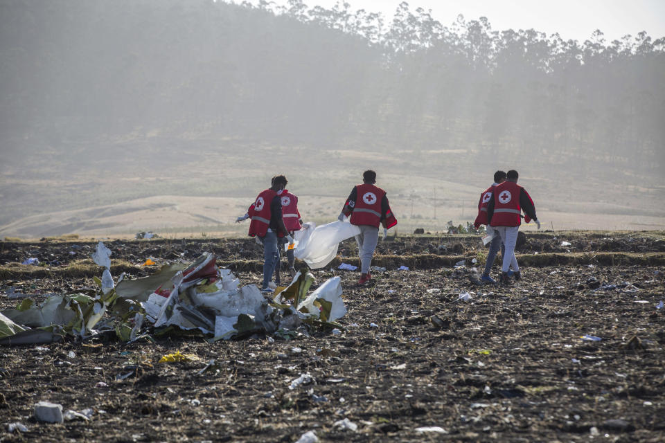 FILE - In this March 11, 2019, file photo, rescuers work at the scene of an Ethiopian Airlines flight crash near Bishoftu, or Debre Zeit, south of Addis Ababa, Ethiopia. Paul Njoroge, who lost his wife and three young children in the March 10 crash of an Ethiopian Airlines' Boeing 737 Max 8 aircraft, believes Boeing should scrap the 737 Max, and he wants the company’s top executives to resign and face criminal charges for not grounding the plane after a deadly accident last October. On Wednesday, July 17, Njoroge will be the first relative of any of the 346 passengers who died in those crashes to testify before Congress. (AP Photo/Mulugeta Ayene)