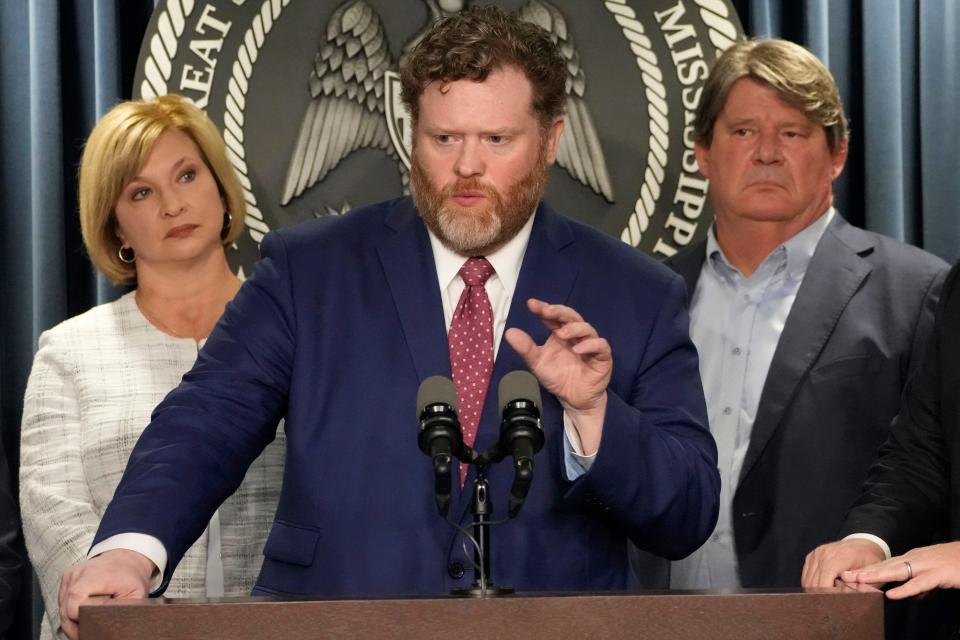 Drew Snyder, executive director of the Mississippi Division of Medicaid, center, responds to Mississippi Gov. Tate Reeves' announcement of a proposal that he says should alleviate financial problems for hospitals, during a news conference Thursday, Sept. 21, 2023, in Jackson, Miss. Dr. LouAnn Woodward, vice chancellor for health affairs and dean of the school of medicine at the University of Mississippi Medical Center, left, stands and listens alongside Kent Nicaud, CEO of Memorial Health System Hospital at Gulfport.