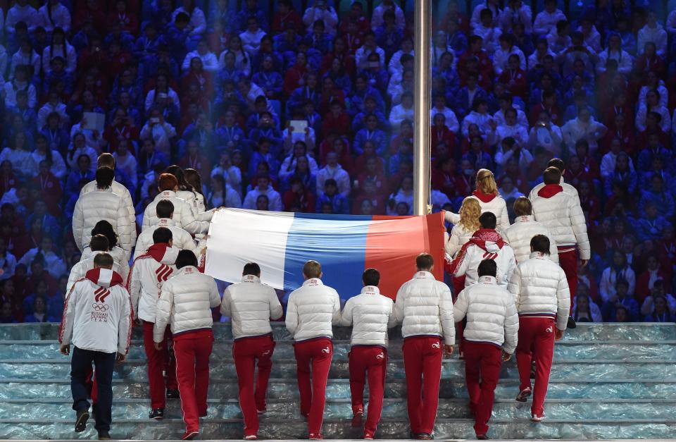 The Russian flag is carried to the podium during the Closing Ceremony of the Sochi Winter Olympics at the Fisht Olympic Stadium on February 23, 2014.   AFP PHOTO / DAMIEN MEYER        (Photo credit should read DAMIEN MEYER/AFP/Getty Images)