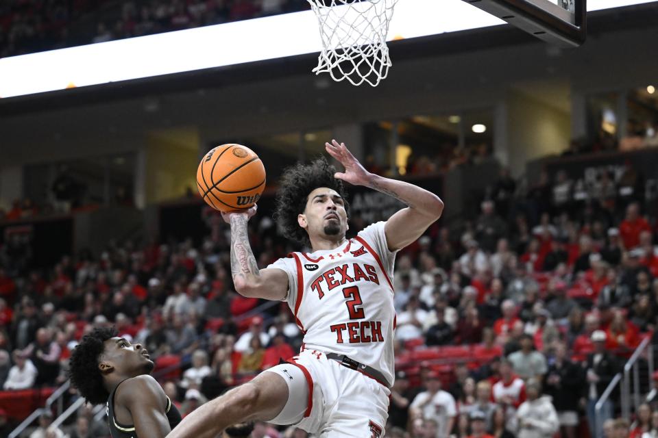 Texas Tech guard Pop Isaacs (2) attempts to layup over Central Florida guard Jaylin Sellers during the first half of an NCAA college basketball game, Saturday, Feb. 10, 2024, in Lubbock, Texas. (AP Photo/Justin Rex)