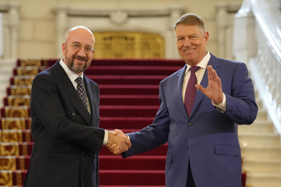 European Council President Charles Michel shakes hands with Romanian President Klaus Iohannis at the Cotroceni Presidential Palace in Bucharest, Romania, Monday, March 27, 2023. (AP Photo/Andreea Alexandru)