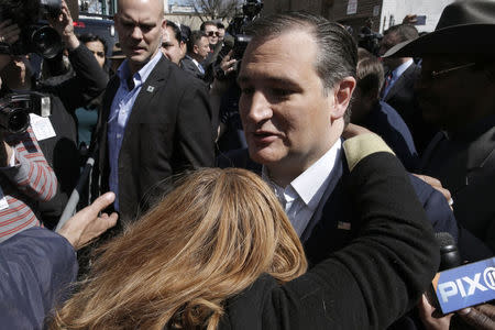 A woman throws her arms around U.S. Republican presidential candidate Ted Cruz as he greets supporters after a campaign stop at the Sabrosura restaurant in the Bronx borough of New York City, April 6, 2016. REUTERS/Mike Segar