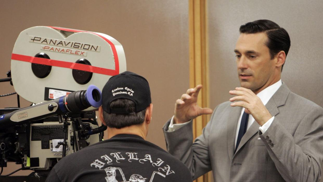 actor jon hamm, right, talks to a cameraman while on the set of mad men, a new amc series about ad