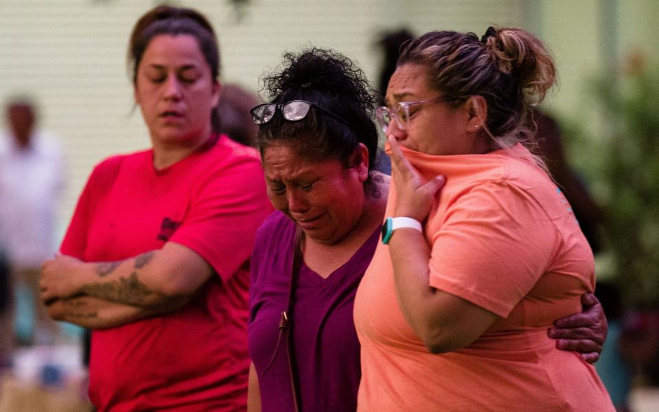 A family as they await news of a missing relative frow the Robb Elementary School massacre in Uvalde, Texas - Jintak Han/ZUMA Press Wire/Shutterstock