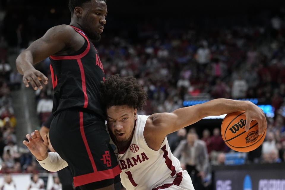 Alabama guard Mark Sears (1) runs into San Diego State guard Darrion Trammell (12) in the first half of a Sweet 16 round college basketball game in the South Regional of the NCAA Tournament, Friday, March 24, 2023, in Louisville, Ky. (AP Photo/John Bazemore)