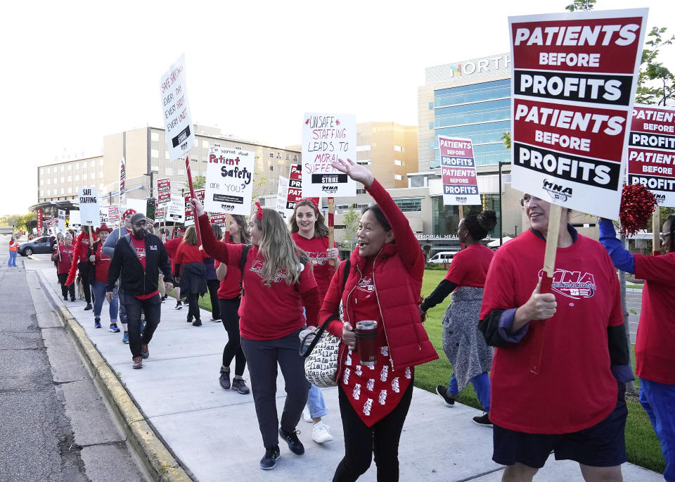 Striking nurses react the a honking vehicle driving by during the first hour of a strike Monday, Sept. 12, 2022 outside North Memorial Health Hospital in Robbinsdale, Minn. Nurses launched a three-day strike over issues of pay and what they say is understaffing that has been worsened by the strains of the coronavirus pandemic. (David Joles/Star Tribune via AP)