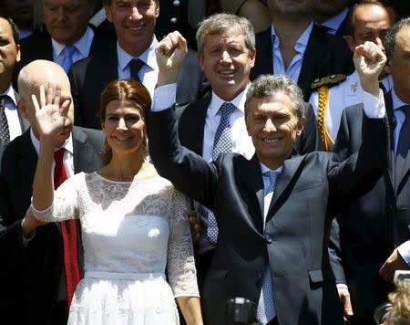 Argentina's President Mauricio Macrii (R) and his wife Juliana Awada wave at the crowd after being sworn-in as president in Buenos Aires, Argentina, December 10, 2015. REUTERS/Enrique Marcarian