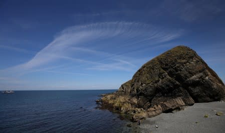 General view showing Cirrus clouds over a rock on rat Island during the Cloud Appreciation Society's gathering in Lundy