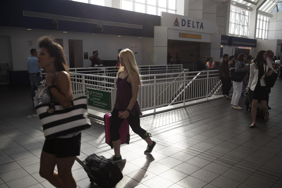 Passengers walk through the Delta Airlines Inc. terminal at LaGuardia Airport in the Queens borough of New York, U.S. on Monday, Aug. 8, 2016.&nbsp;