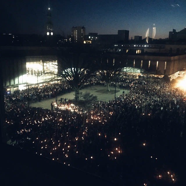 People gather at University of North Carolina Chapel Hill for a candlelight vigil in honor of three shooting victims on Wed. February 11, 2015. 