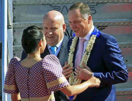 New Zealand Prime Minister John Key (R) chats to a well-wisher after he receive a garland upon arrival at the international airport in Manila November 17, 2015. REUTERS/Romeo Ranoco