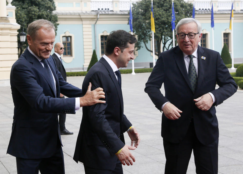 FILE From left; European Council President Donald Tusk, Ukrainian President Volodymyr Zelenskyy, and European Commission President Jean-Claude Juncker, greet each other ahead of their meeting in Kiev, Ukraine, Monday, July 8, 2019. As a political novice running to be Ukraine’s president, Volodymyr Zelenskyy vowed to reach out to Russia-backed rebels in the east who were fighting Ukrainian forces and make strides toward resolving the conflict. The assurances contributed to his landslide victory in 2019. (AP Photo/Efrem Lukatsky, File)