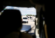 U.S. President Donald Trump's motorcade is seen en route to Trump National Golf Club Jupiter in Jupiter, Florida, U.S., November 24, 2017. REUTERS/Eric Thayer