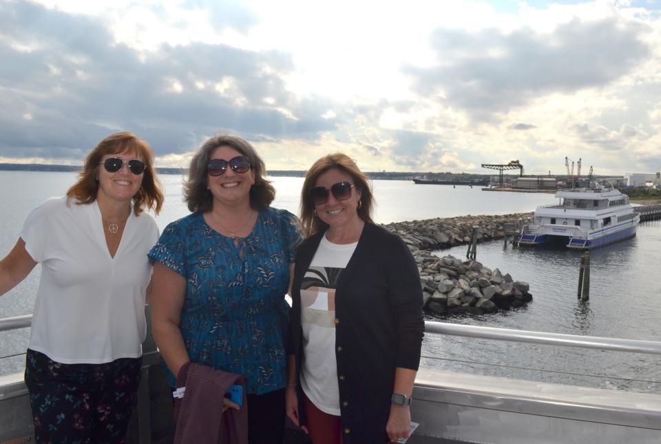 From left, state Rep. Michelle McGaw, state Sen. Dawn Euer and state Sen. Alana DiMario prepare to board a ferry for a tour of the Block Island wind farm on Tuesday, Sept. 20, 2022.