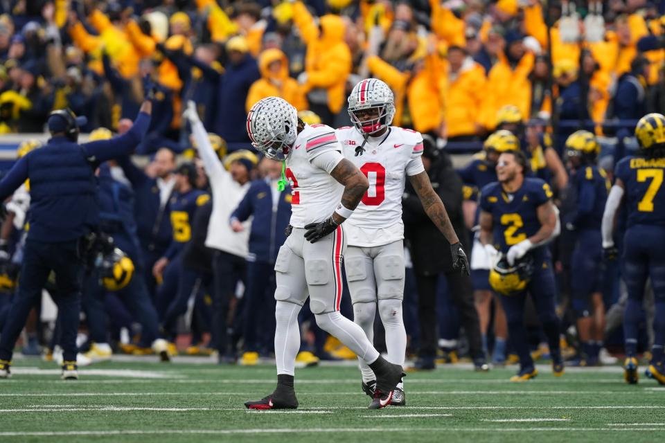 Nov 25, 2023; Ann Arbor, Michigan, USA; After a Michigan Wolverines interception all but ended the game, Ohio State Buckeyes wide receiver Emeka Egbuka (2) and wide receiver Xavier Johnson (0) walk off the field in the final seconds of the second half of the NCAA football game at Michigan Stadium. Ohio State lost 30-24.