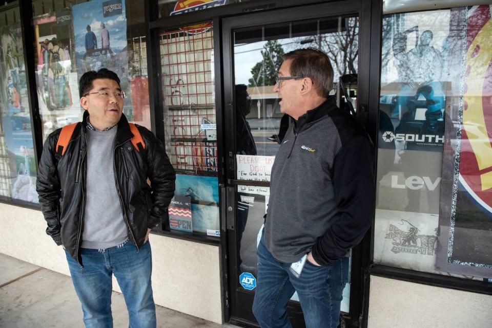 Modesto councilmember Nick Bavaro, right, talks with Carver Road business owner Dale Jin Yoo, left, in Modesto, Calif., Wednesday, March 29, 2023. Andy Alfaro/aalfaro@modbee.com