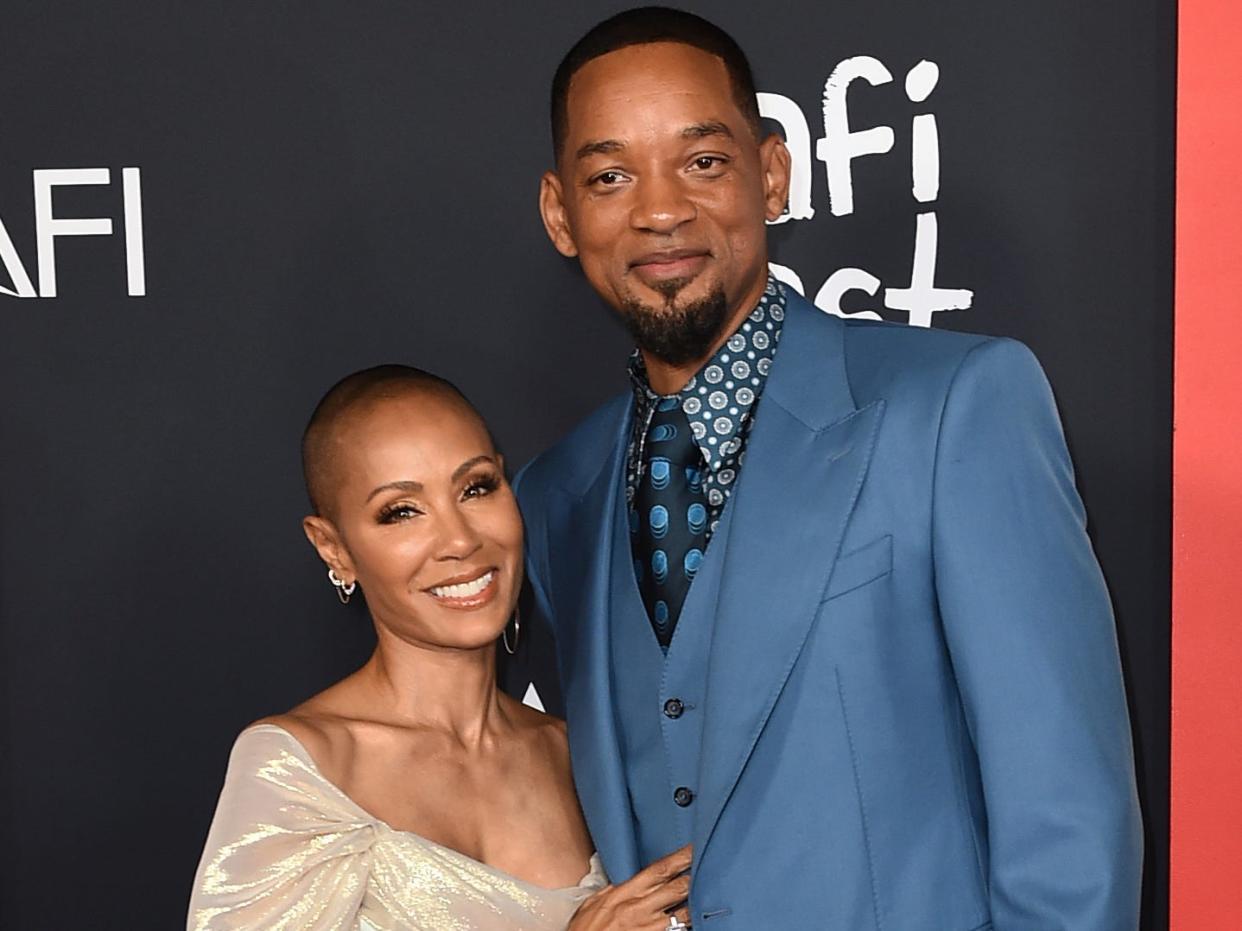 Jada Pinkett Smith and Will Smith posing together at the red carpet premiere of the film "King Richard" in November 2021.